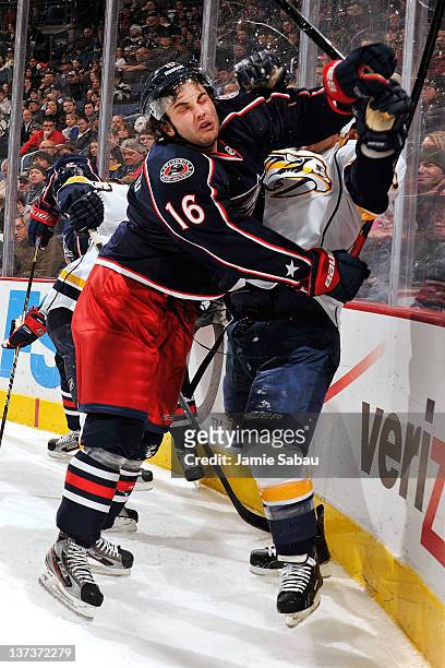 Derick Brassard of the Columbus Blue Jackets checks Jordin Tootoo of the Nashville Predators into the boards during the second period on January 19,...