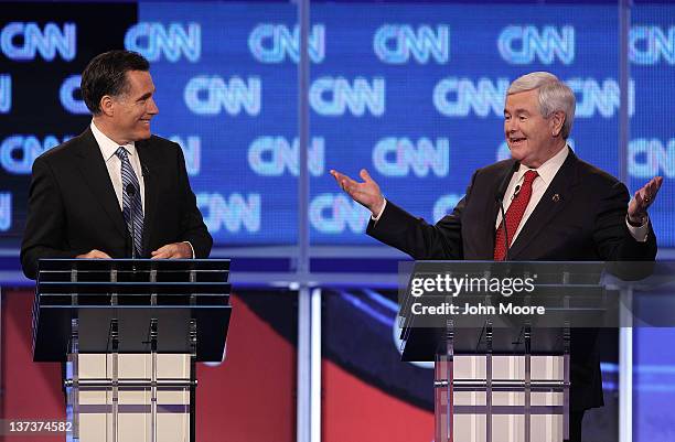 Republican presidential candidate former Speaker of the House Newt Gingrich , next to former Massachusetts Gov. Mitt Romney, makes a point during a...