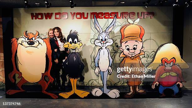 Lili Ghinita and Anola Phoumiphat pose with cartoon characters at the grand opening of The Chuck Jones Experience at the Circus Circus Hotel-Casino...