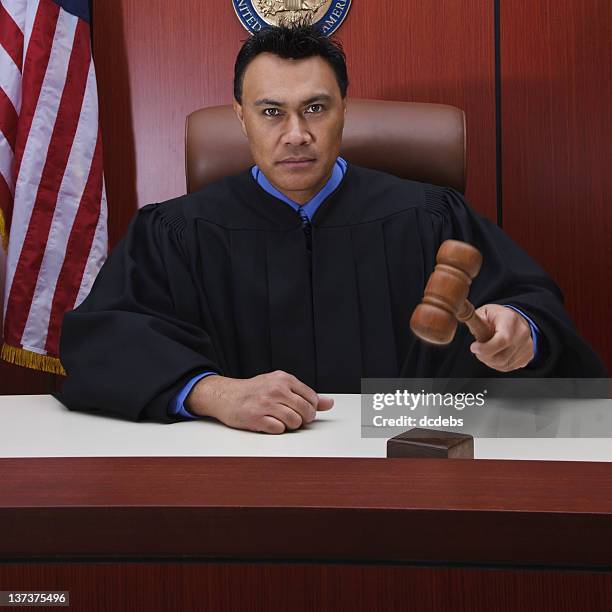 male judge with gavel in courtroom - gavel courtroom stock pictures, royalty-free photos & images