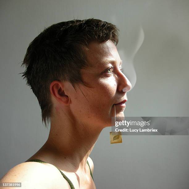 woman with steaming nose - sachet de thé photos et images de collection