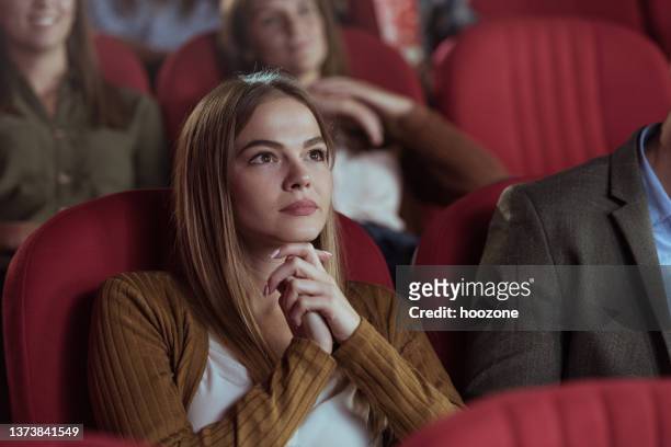 beautiful women watching movie in cinema - film and television screening stockfoto's en -beelden