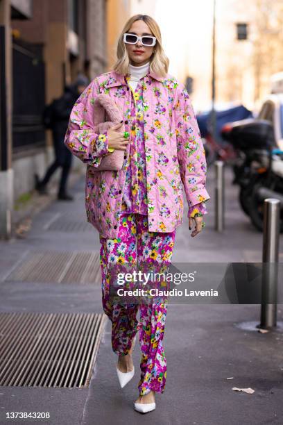 Candela Pelizza poses ahead of the MSGM fashion show wearing a pink floral printed sequins shirt, pink floral printed pants and jacket, pink fur bag...