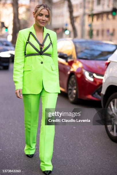 Veronica Ferraro poses ahead of the MSGM fashion show wearing a neon green suit and black leather bralette during the Milan Fashion Week Fall/Winter...