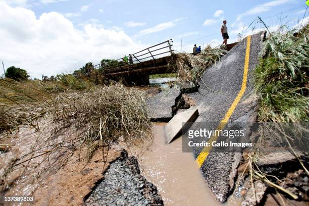 Damaged roads caused by flooding on January 19, 2012 in Hoedspruit, South Africa. People were plucked from the roofs of their submerged houses and...