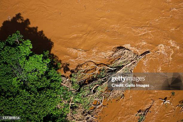 Aerial view of a flooded area on January 19, 2012 in Hoedspruit, South Africa. People were plucked from the roofs of their submerged houses and...