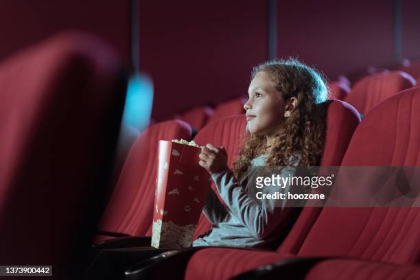 little girl in cinema watching movie - film and television screening stockfoto's en -beelden