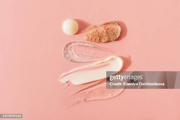 white cream for the face on pink background. body care and beauty. skin care product - crema fotografías e imágenes de stock