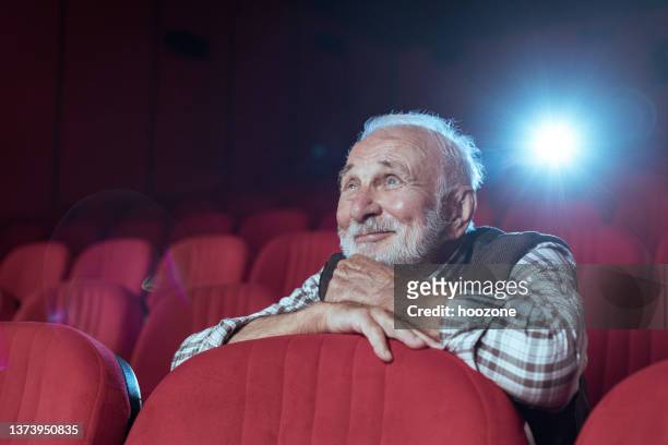 senior men in cinema - film and television screening stockfoto's en -beelden