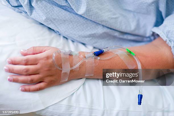 close up of iv drip in patient's hand - iv going into an arm stock pictures, royalty-free photos & images