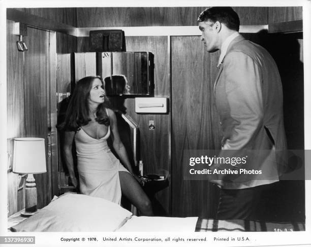 Richard Kiel backing actress Barbara Bach into a corner in a scene from the film 'The Spy Who Loved Me', 1977.