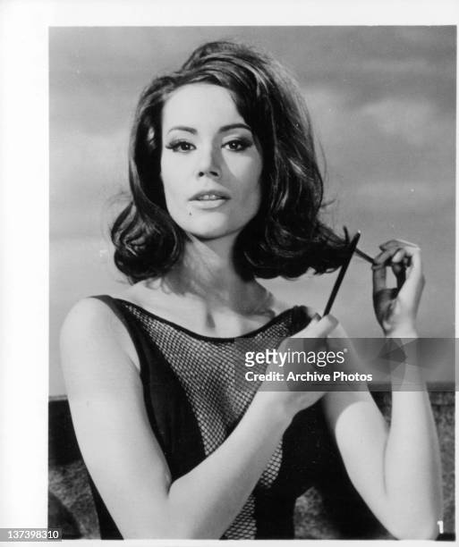 Claudine Auger combing her hair in a scene from the film 'Thunderball', 1965.