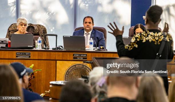 City of North Miami Beach Mayor Anthony F. DeFillipo flanked by Commissioners Phyllis Smith and Fortuna Smukler listen as a resident speaks at the...