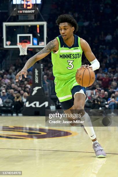Jaden McDaniels of the Minnesota Timberwolves dribbles the ball to the basket during the first quarter against the Cleveland Cavaliers at Rocket...