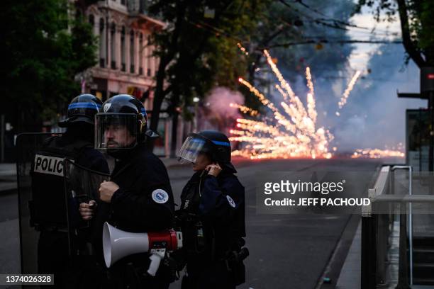 French riot police stand guard during clashes in Lyon, south-eastern France, on June 30 three days after a 17-year-old boy was shot in the chest by...