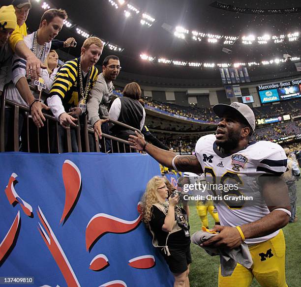 Kevin Koger of the Michigan Wolverines celebrates with fasn after they won 23-20 in overtime against the Virginia Tech Hokies during the Allstate...