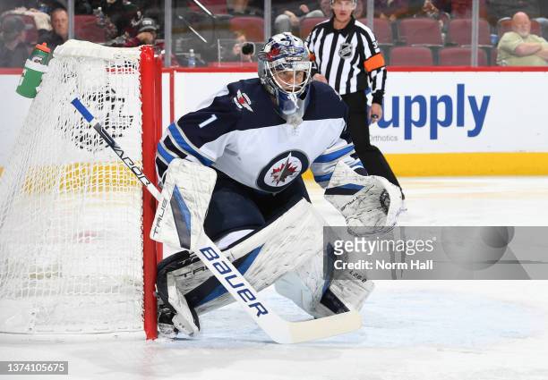 Eric Comrie of the Winnipeg Jets gets ready to make a save against the Arizona Coyotes at Gila River Arena on February 27, 2022 in Glendale, Arizona.