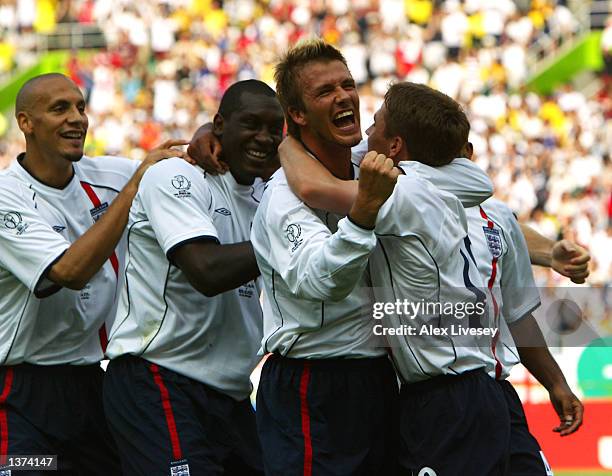 Michael Owen of England celebrates with team mates David Beckham , Emile Heskey and Rio Ferdinand after scoring the opening goal in the first half of...