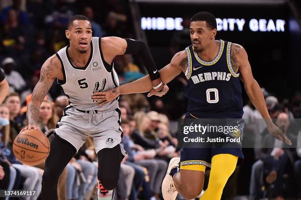 Dejounte Murray of the San Antonio Spurs brings the ball up court against De'Anthony Melton of the Memphis Grizzlies during the second half at...