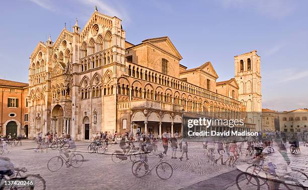 bike riders and pedestrians and the basilica. - ferrara stock pictures, royalty-free photos & images
