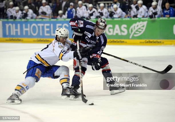 Laurin Braun of Berlin is challenged by David Cespiva of Muenchen during the DEL match between Eisbaeren Berlin and EHC Muenchen at O2 World on...