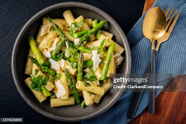 pasta with fresh asparagus and a lemon and parmesan dressing - asparagus stock pictures, royalty-free photos & images