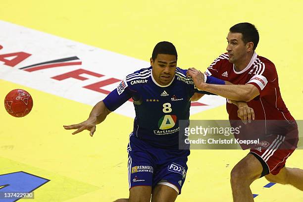 Ferenc Ilyes of Hungary defends against Daniel Narcisse of France during the Men's European Handball Championship group C match between France and...