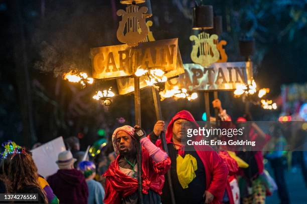 Flambeaux light the way for the 2022 Krewe of Orpheus parade that takes place on the traditional Uptown parade route on February 28, 2022 in New...