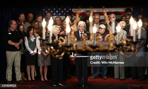 Seen through a chandelier, Republican presidential candidate, former Speaker of the House Newt Gingrich, speaks during a town hall style campaign...
