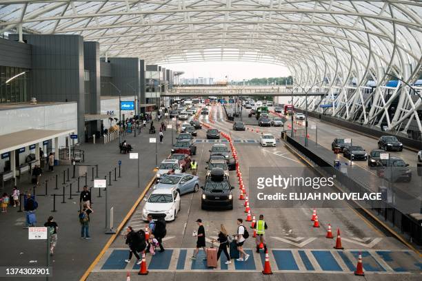 Travelers are seen ahead of the fourth of July holiday weekend at Hartsfield-Jackson Atlanta International Airport on June 30 in Atlanta, Georgia....