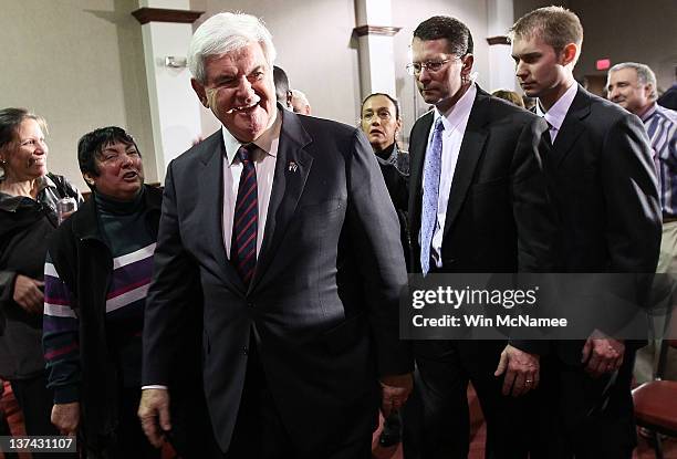 Republican presidential candidate, former Speaker of the House Newt Gingrich, departs after answering questions from the press following a town hall...