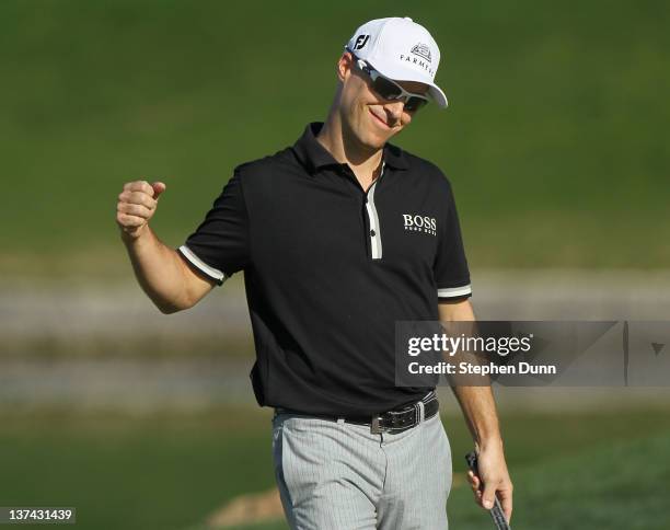 Ben Crane celebrates after making a birdie putt on the 9th hole, his last of the round, to go 16 under par for the tournament during the second round...