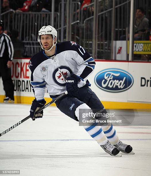 Eric Fehr of the Winnipeg Jets skates against the New Jersey Devils at the Prudential Center on January 17, 2012 in Newark, New Jersey. The Devils...