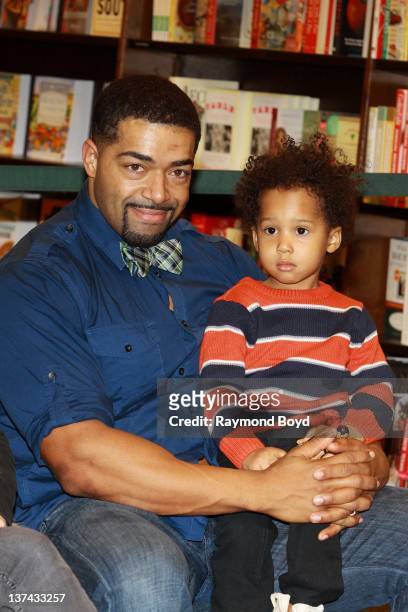 Wrestler David Otunga and his son David Otunga, Jr. Poses for photos as his fiance, and mother of his son, singer and actress Jennifer Hudson signs...