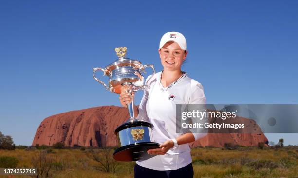 In this Handout Photo provided by Tennis Australia, Ashleigh Barty poses with the Daphne Akhurst Memorial Cup as she visits Uluru in the Uluru-Kata...