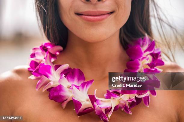 Lei hawaii welcome necklace of fresh orchids flowers garland on woman's neck. Aloha spirit. Hula dancer at luau beach party