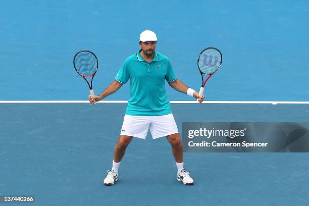 Henri Leconte of France holds two racquets during his legends match with partner Guy Forget of France against Darren Cahill of Australia and Richard...