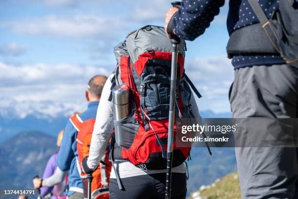 group of hikers walking on mountain - ages 65 70 stockfoto's en -beelden