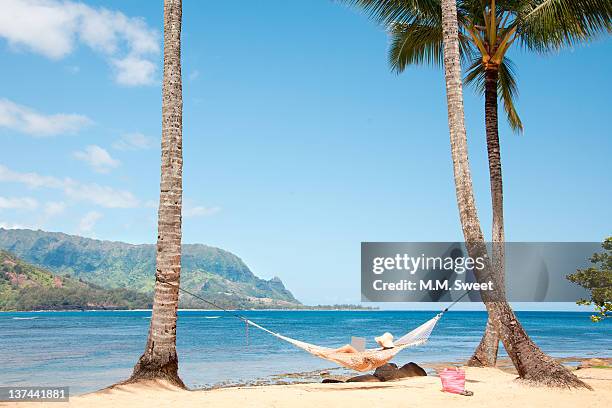 woman relaxing at tropical resort - princeville stock pictures, royalty-free photos & images
