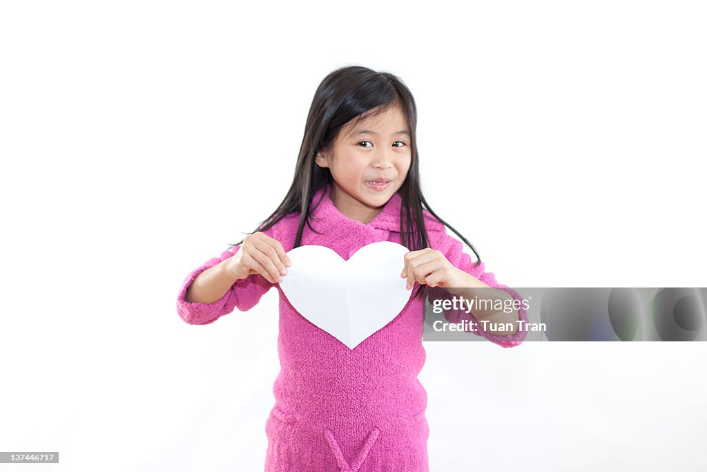 Girl holding paper heart
