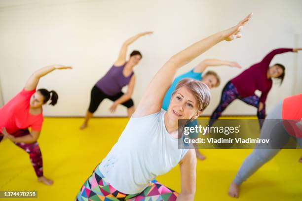 ladies in an exercise class - obesity trainer stock pictures, royalty-free photos & images