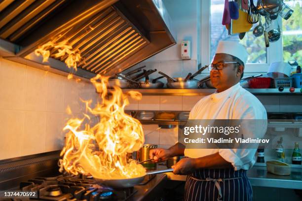 ein koch grillt ein indisches curry - chef tossing fire stock-fotos und bilder