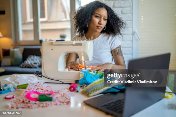 woman running a sewing from home business - e learning design stock pictures, royalty-free photos & images