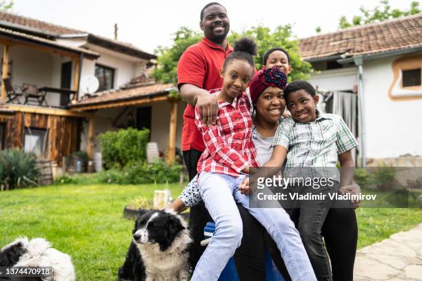 the whole family having a group hug - jamaican ethnicity stock pictures, royalty-free photos & images