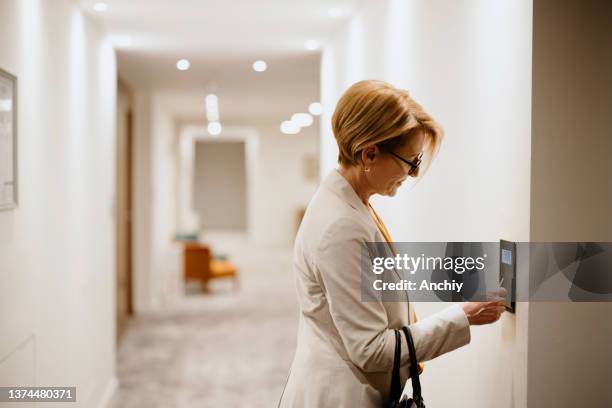 businesswoman using room keycard to unlock the door and enter the hotel bedroom - entering restaurant stock pictures, royalty-free photos & images