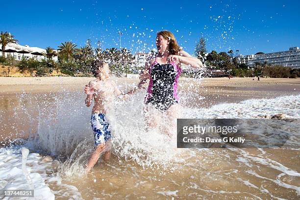 boy and his mother at beach - albufeira stock pictures, royalty-free photos & images