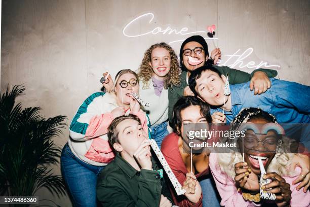 happy multiracial male and female students with props against wall in college dorm - college dorm party stock-fotos und bilder