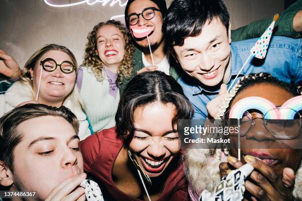 carefree multiracial roommates with props enjoying in college dorm - campus party fotografías e imágenes de stock