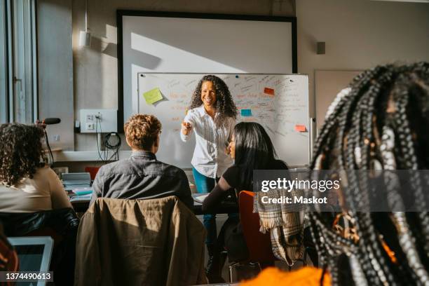 smiling professor teaching students in classroom at community college - 社会人学生 ストックフォトと画像