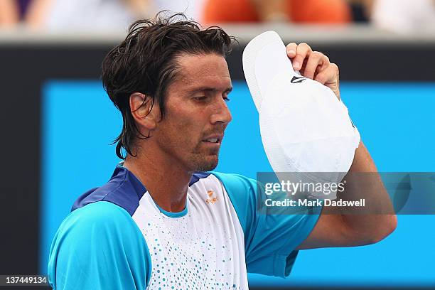 Juan Ignacio Chela of Argentina takes a break between points in his third round match match against David Ferrer of Spain during day six of the 2012...
